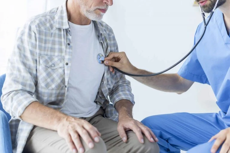 Home health aid checks the vital signs of a senior citizen