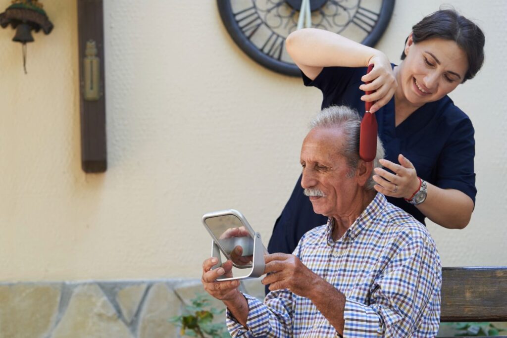 In home care companion helping a man get ready for a date